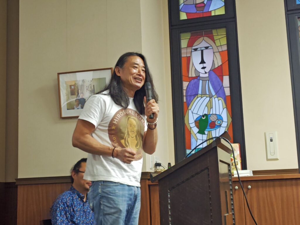 Photo of Mr. Hirosuke Hoashi speaking about how he came to make Myanmar curry and his passionate commitment to support the people of Myanmar.