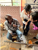 Moe (right) seeking advice from artificial limb craftsman