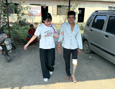 Rinka assisting young man with new leg